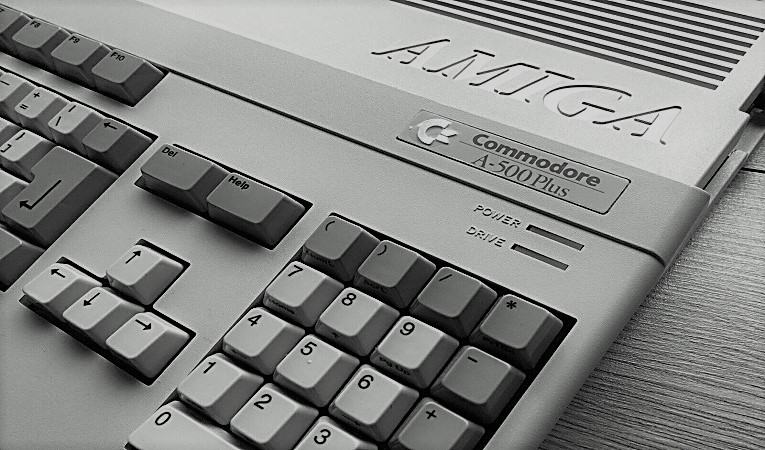 The acquisition of Amiga by Commodore and Atari's involvement, and what if Atari had won the bid?